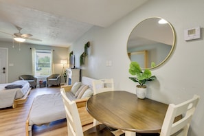 A room with a dining table, chairs, a ceiling fan, a large mirror, and a potted plant. - Walk to Grand Lagoon! Couples Haven 2 Mi to Beach (Panama City Beach)
