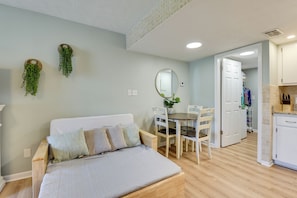 A room with a bed, a dining table with chairs, a kitchen area, and a hallway. - Walk to Grand Lagoon! Couples Haven 2 Mi to Beach (Panama City Beach)
