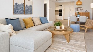 A modern living room with a sofa, coffee table, and chairs. - Garden apartment in La Cala Sunset (Mijas Costa)