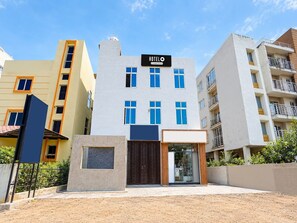 A hotel with a prominent sign, a gated entrance, and a modern facade. - Deluxe Room Hotel Khushi in (Bhubaneshwar)