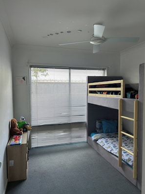 A child's bedroom with bunk beds, a desk, a chair, and a window with blinds. - Spacious 3-bedroom House Rental in Waterford, Australia (Waterford)