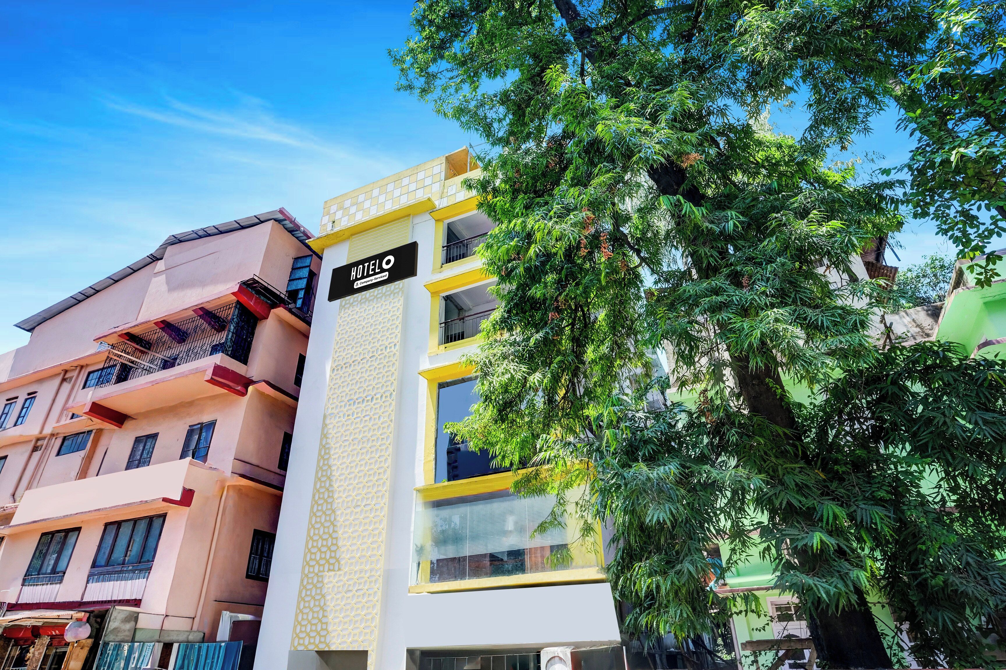 A multi-story hotel with a sign indicating it is company serviced.