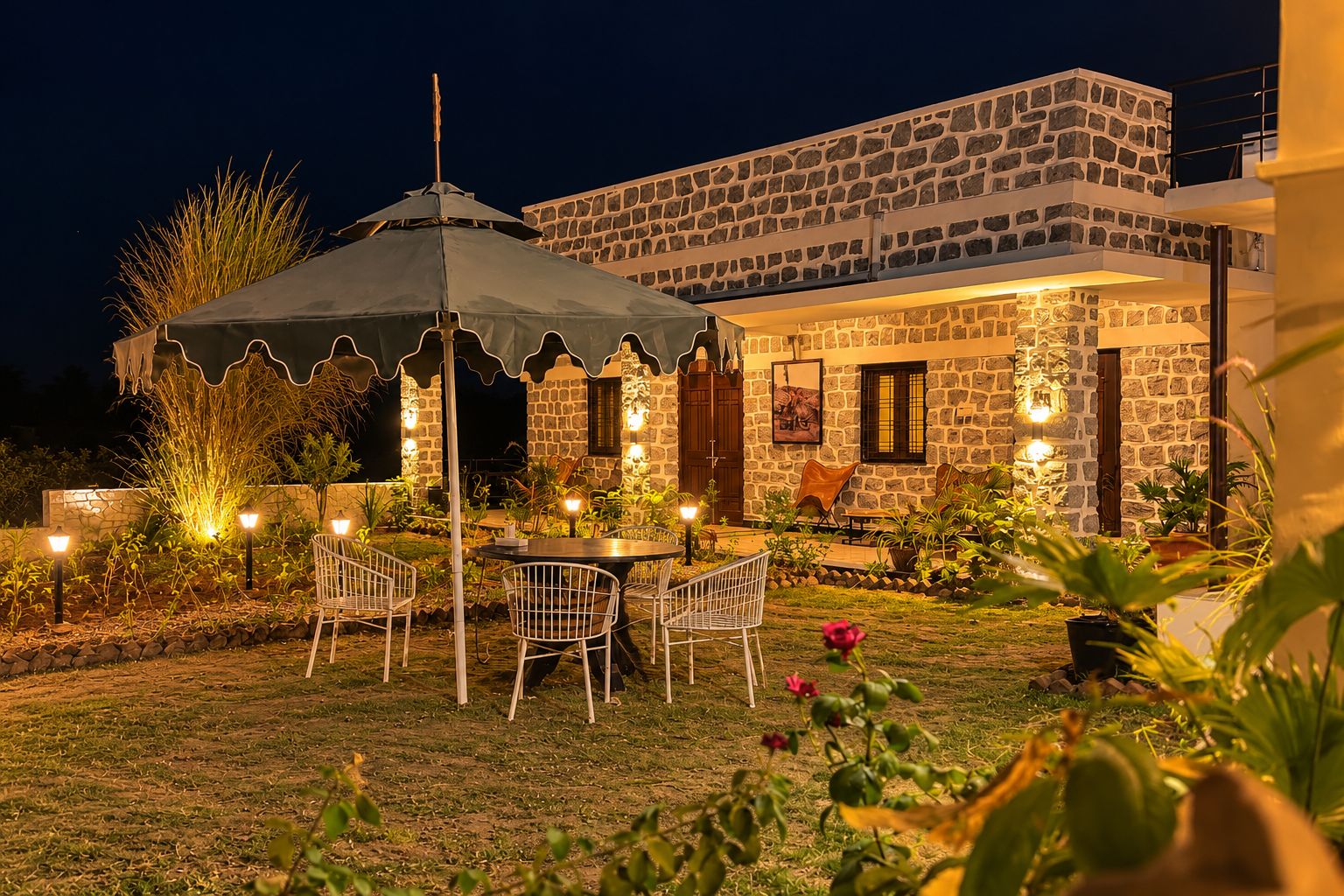 Un bâtiment en pierre doté d’un patio, d’un espace extérieur aménagé pour s’asseoir et d’un éclairage décoratif.