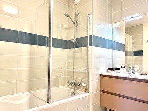 A modern bathroom with a glass-enclosed shower, a white bathtub, and a vanity with a mirror. - La Belle Vue (4 people) Terrace with a view of the mountains. Indoor parking (Saint-Gervais-les-Bains)