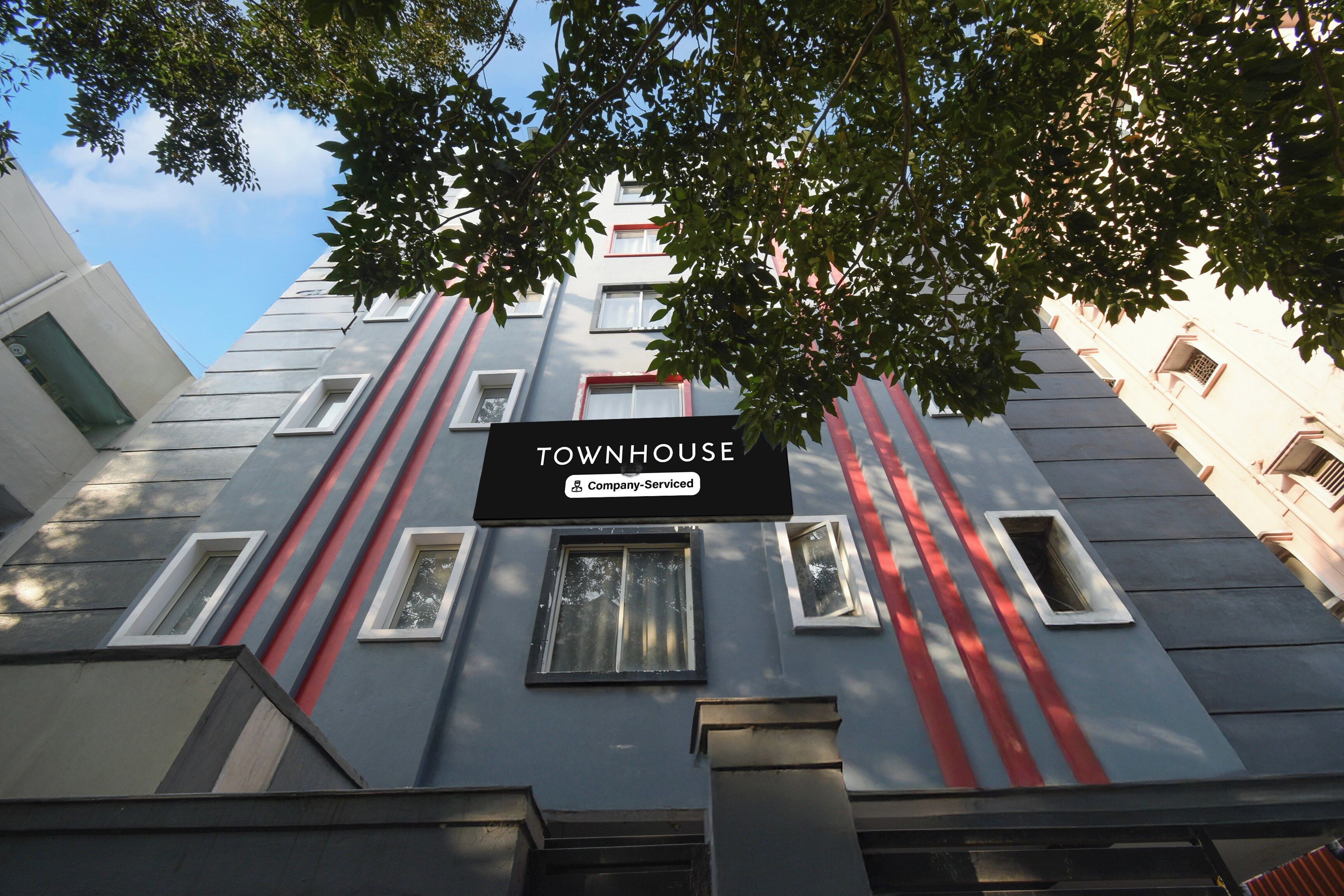 A building with a sign reading 'TOWNHOUSE Company-Serviced.'