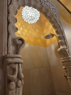 An ornate architectural detail with a geometric ceiling design and a shower fixture. - New Listing (Orgaz)