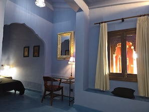 A room with a desk, chair, and a large mirror on the wall. - New Listing (Orgaz)