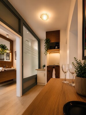 A modern kitchen with a wooden countertop, a built-in oven, and a coffee machine. - New Listing (Magdeburg)