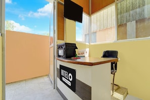 A hotel reception desk with a sign indicating it is company-serviced.