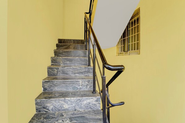 A staircase with stone steps and metal railings.