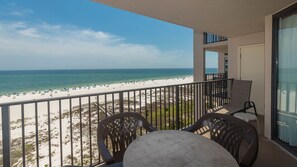 A balcony with a view of a beach and ocean. - Phoenix East 808 1 Bedroom Condo (Orange Beach)
