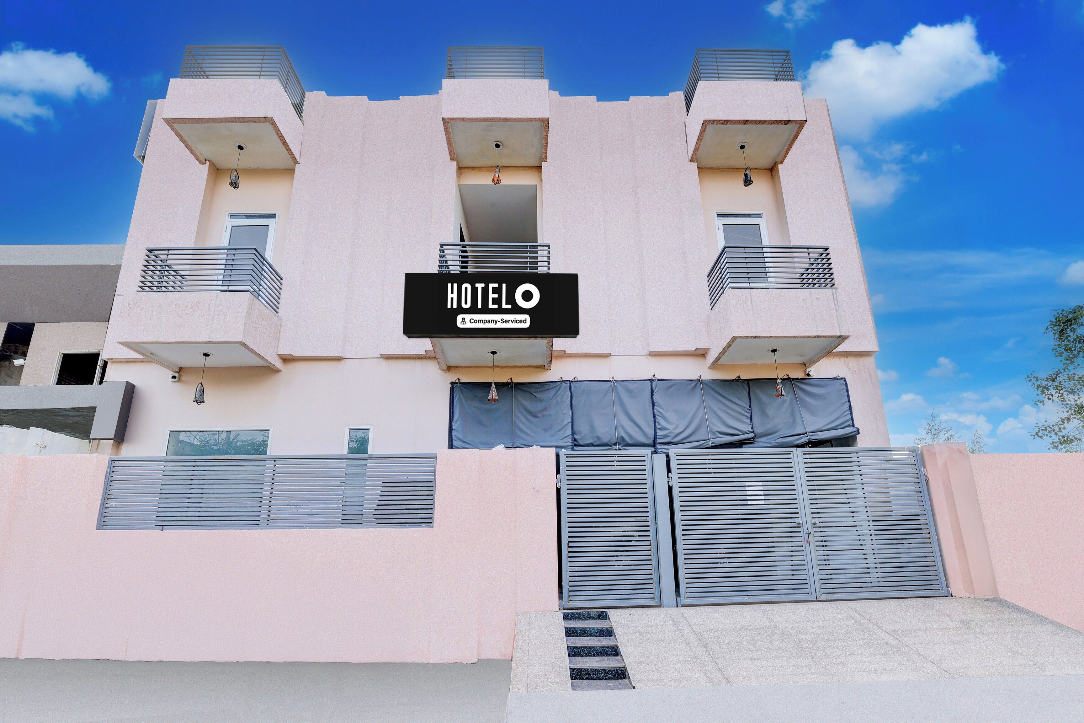 A hotel building with a sign indicating it is company-serviced.