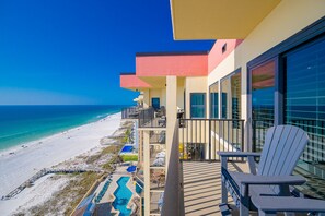 A balcony with a view of a beach and ocean, outdoor seating, and a pool area. - Phoenix Ii 2153 3 Bedroom Condo (Orange Beach)