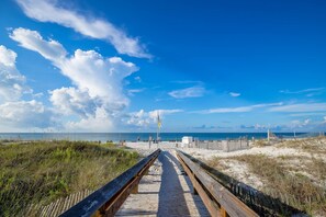 A wooden boardwalk leading to a beach with a clear view of the ocean and a sandy path. - Phoenix East 1105 1 Bedroom Condo (Orange Beach)