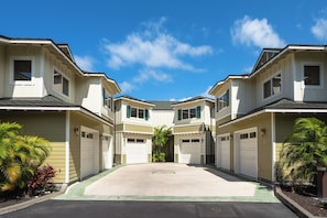 A symmetrical residential complex with multiple garage doors, a central paved area, and surrounding greenery. - Na Hale O Keauhou#N6: Beautiful Corner Townhome with Ac! (Kailua Kona)