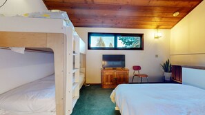 A room with bunk beds, a television, a desk, and a chair. - Meadow Ridge #8 3 Bedroom Condo (Mammoth Lakes)