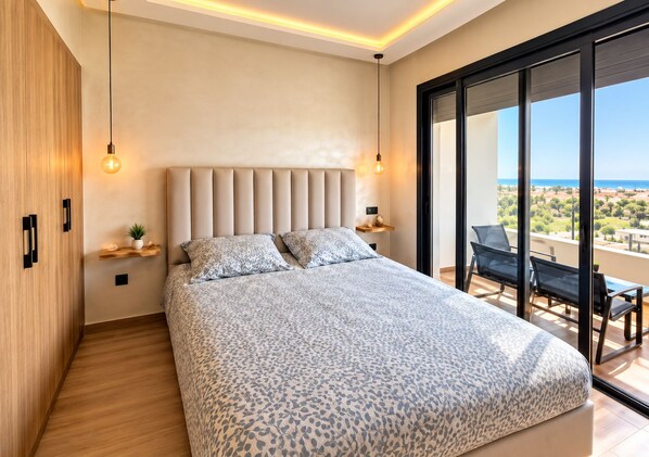 A modern bedroom with a large bed, a view of the outdoors, and a balcony with seating. - New Listing (Âïn-Harrouda)