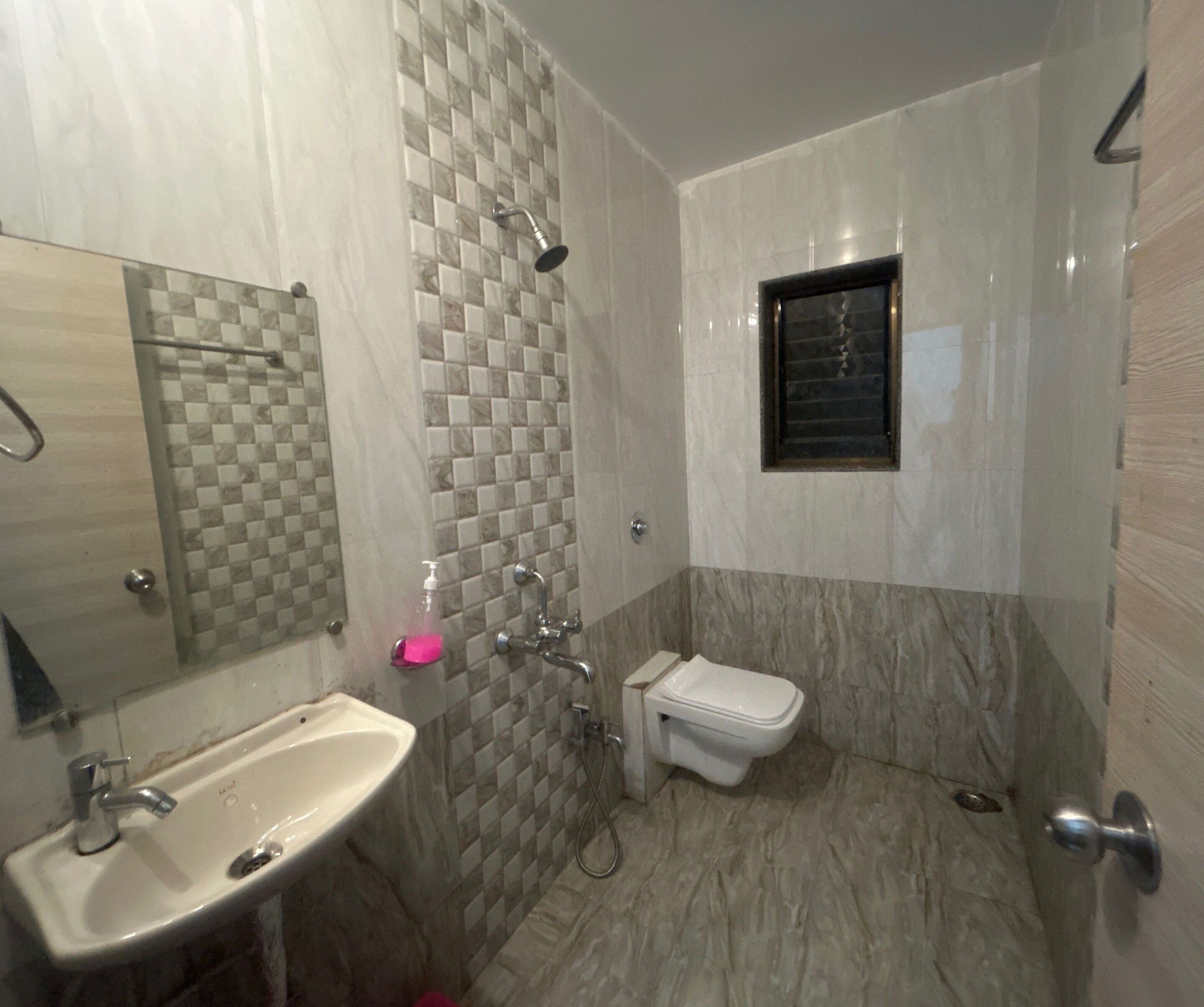 A bathroom with a sink, toilet, and shower.