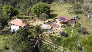 A residential property with a house, a swimming pool, and a garden.
