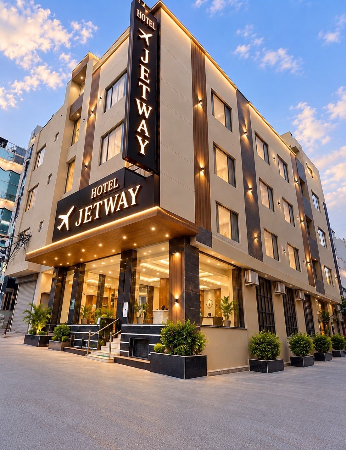 A modern hotel with a prominent sign, multiple floors, and a well-lit entrance.