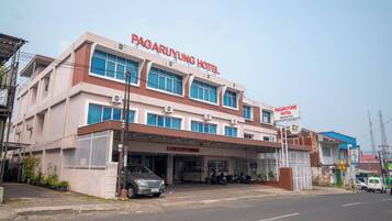 A hotel with a sign reading 'PAGARUYUNG HOTEL' and a visible entrance with a car parked outside.