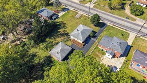 An aerial view of a residential area with houses, a road, and a railway track. - Spacious home near Bourbon Trail & Churchill Downs (Louisville)