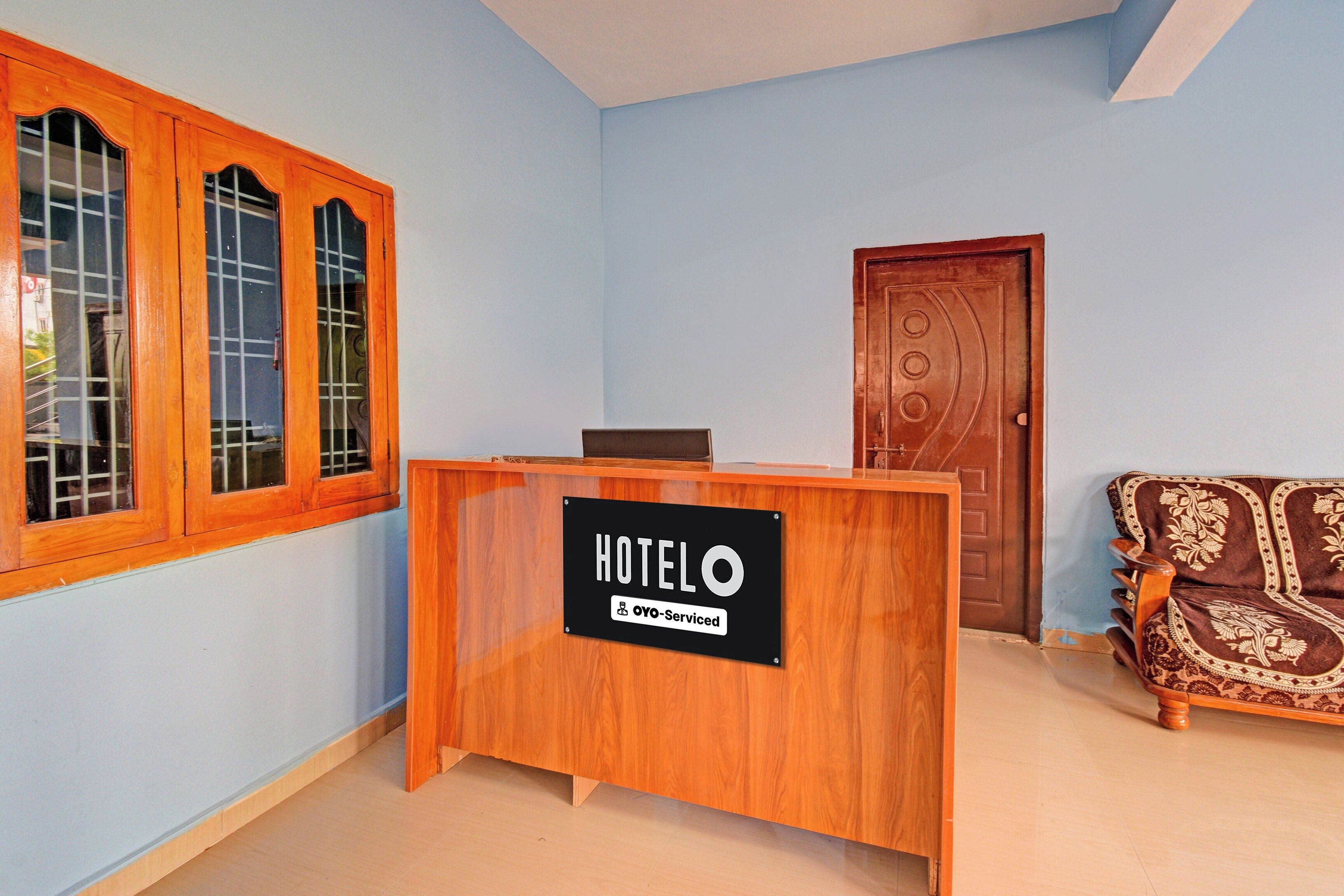 Ein Hotel-Rezeptionsschalter mit einem Schild, das angibt, dass er von Oyo verwaltet wird.