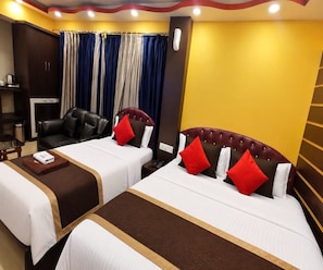 A hotel room with two beds, a desk, a chair, and a wardrobe. - Deluxe Room Jessore Road Kolkata Airport (Barakpur)