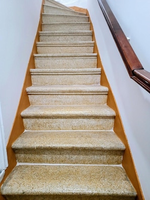 A staircase with stone steps and a wooden handrail. - Stone House 'Medieval-Style 1905 Stone House' (Πυργί)