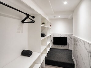 A modern bathroom with a built-in TV, marble backsplash, and a towel rack. - ST14 | 1-Bed Flat Canterbury | Parking & WiFi, contractors (Kent)