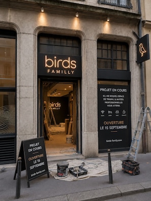 A storefront with a neon sign for 'birds FAMILYLY' and a construction sign indicating an opening on September 15. - SmartStay Bird Family Bellecour - Lyon (Lyon)
