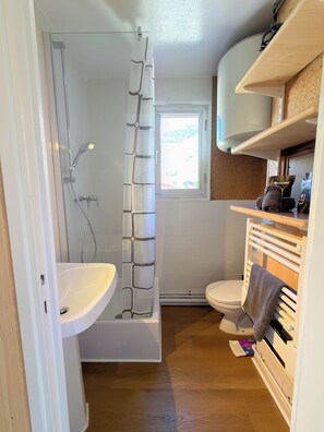 Ein Badezimmer mit Dusche, Toilette und Waschbecken.