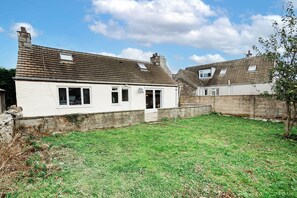 A two-story white house with a tiled roof, a front door, and a small front yard. - The Forest Mews - 3 Bed Cottage Dalbeattie (Dumfries and Galloway)