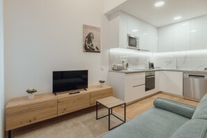 A modern kitchen with white cabinets, a microwave, and a dishwasher. - Modern Lapa Duplex D by Vacationy (Porto)