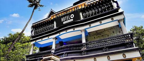 A multi-story hotel with a prominent sign reading 'HOTEL & Company-Service'.