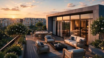 A modern outdoor living area with a dining set, sofas, and a coffee table.