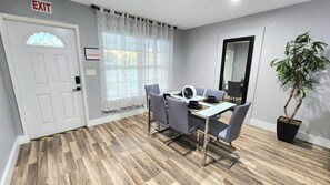 A dining area with a table, chairs, and a potted plant. - Pool Home w/ 2 Kings near Beach, FLL & Hard Rock (Hollywood)