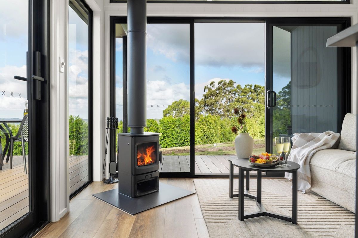 Fireplace and lounge with view through glass doors