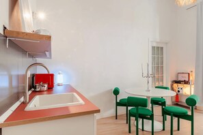 A compact kitchen with a sink, a red appliance, and a white countertop. - New Listing (Napoli)