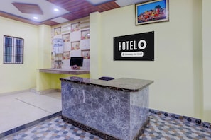 A hotel reception desk with a marble top, a water dispenser, and a framed picture on the wall. - Super Hotel O Banaras Junction BLW (Varanasi)