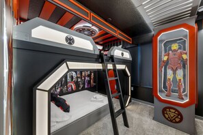 A bunk bed with a ladder, a wall with framed posters, and a display case with a figure. - BRAND NEW 5BR w Pool  Themed Rooms   Lazy River 16220 (Clermont)