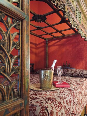 A room with a patterned tablecloth, a metal bucket with a bottle, and two glasses. - New Listing (Orgaz)