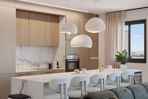 A modern kitchen with a marble backsplash, wooden cabinets, and a central island with bar stools. - Stunning Coastal Escape with Private Balcony (Nahariya)