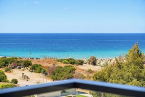 A coastal view with a clear sky, a sandy beach, and a few buildings in the distance. - Luxury Coastal Escape in Achziv with Sea Views (Nahariya)