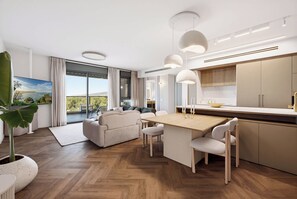 A modern kitchen with a central island, pendant lighting, and a view to the outdoors. - Luxury Coastal Escape in Achziv with Sea Views (Nahariya)
