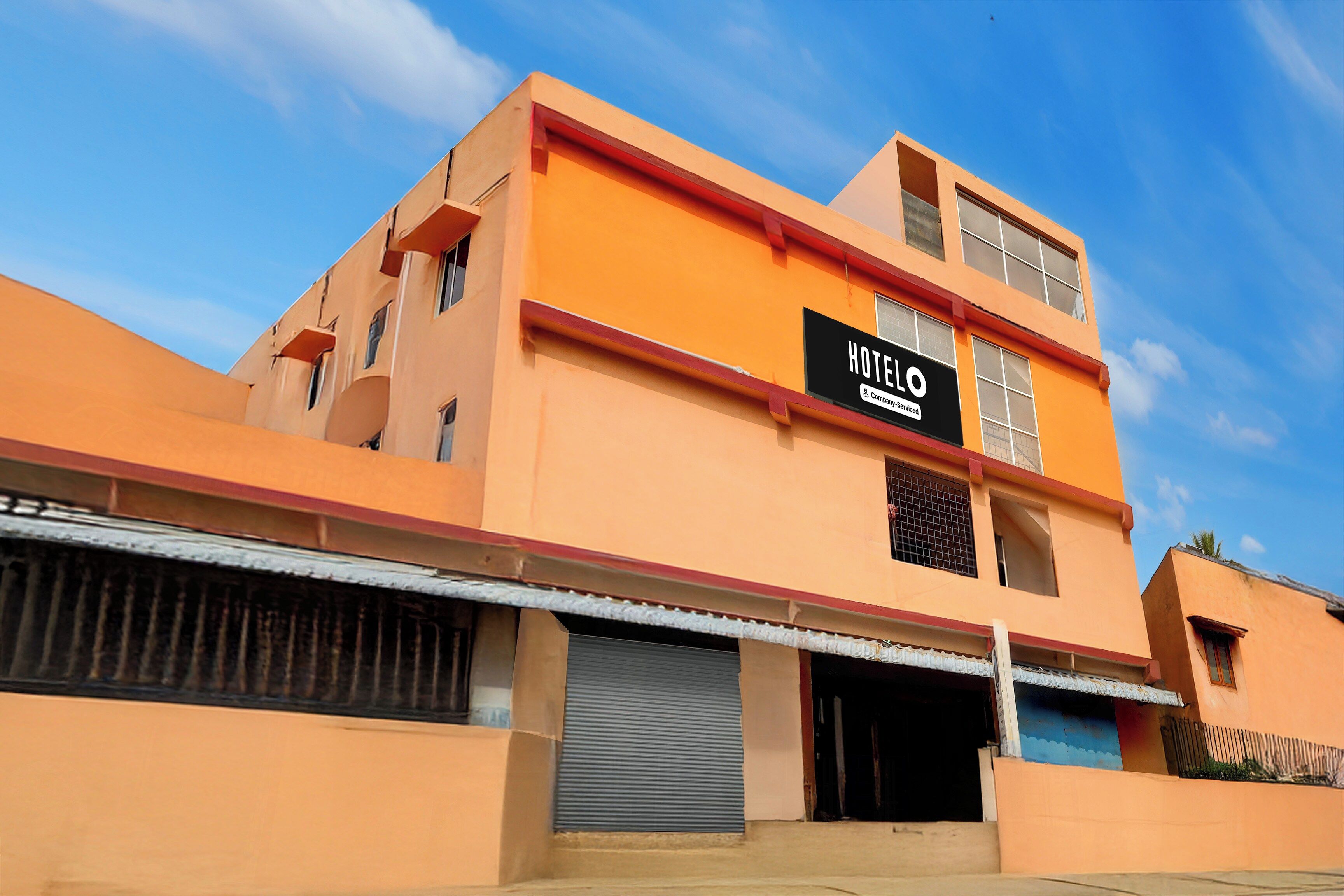A multi-story hotel with a prominent 'HOTEL' sign on the facade.
