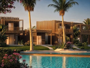 A modern resort with a pool, palm trees, and a well-maintained garden. - Club del Sole Laguna Boutique Resort (Riccione)