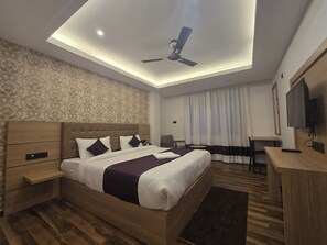 A modern hotel room with a bed, a desk, a ceiling fan, and a television. - The Pine Crest Hotel & Lounge Gangtok (Gangtok)