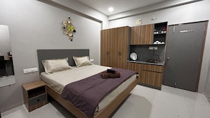 Ein Schlafzimmer mit Bett, Kleiderschrank, Nachttisch und Wanduhr.