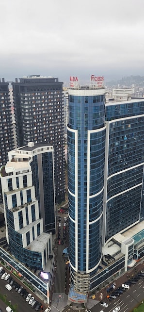 Un edificio de gran altura con fachada curva y un letrero llamativo en la parte superior.